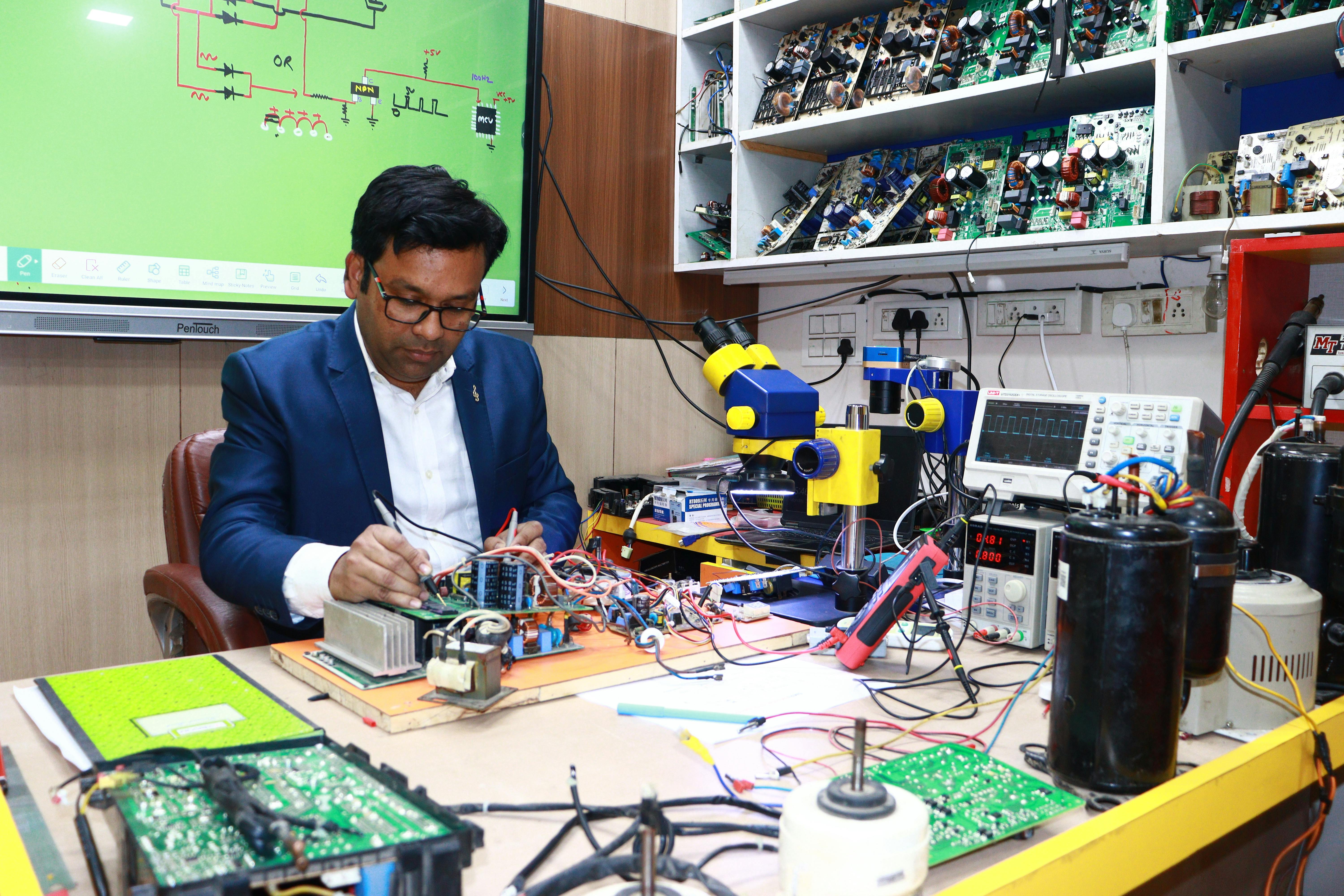 Electronics technician working at a repair bench