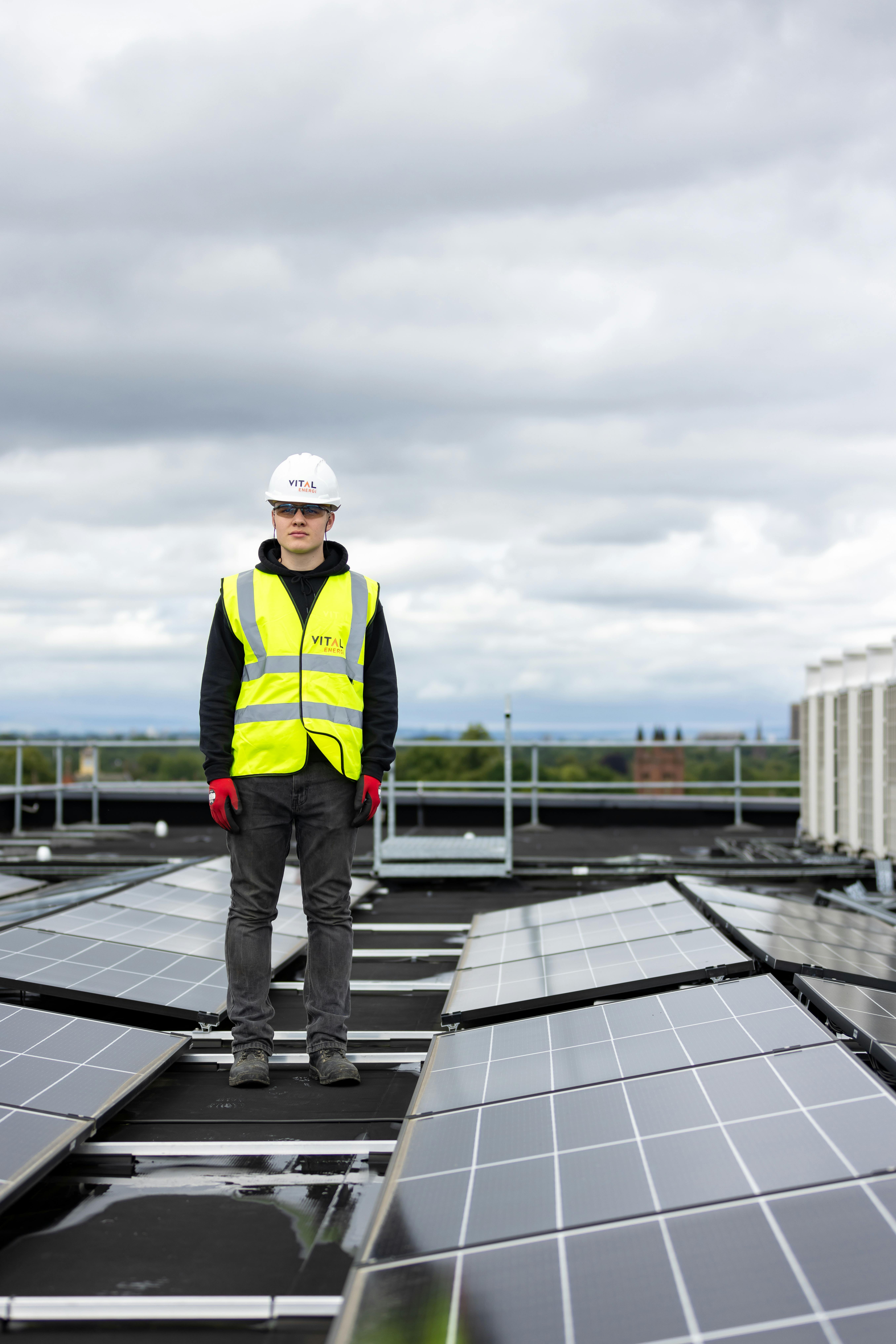 Renewable energy technician on a rooftop solar installation